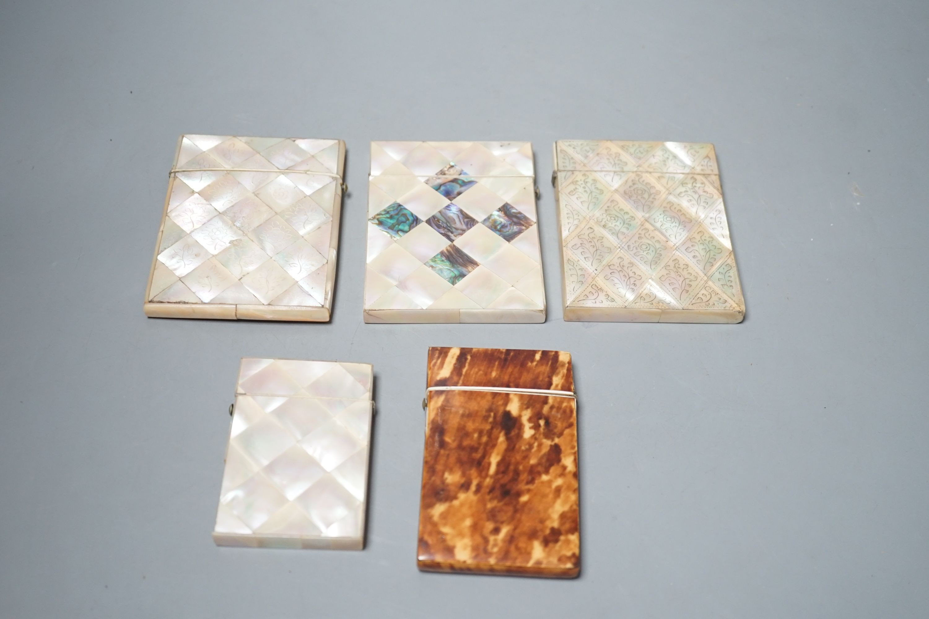 A selection of four mother of pearl card cases, together with another tortoiseshell card case inlaid with bone (5)